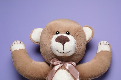 Photo of Cute teddy bear on light purple background