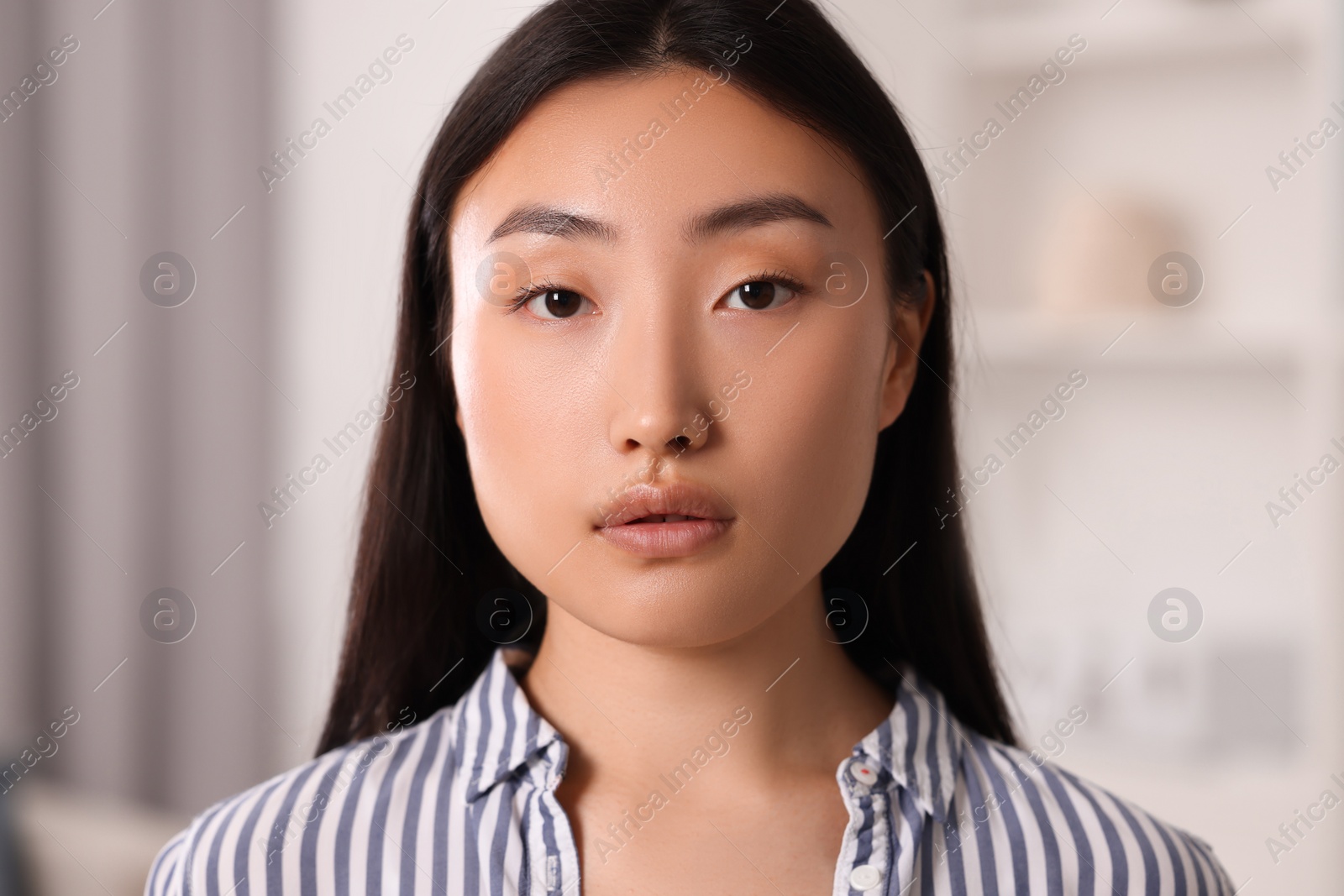 Photo of Portrait of beautiful young woman on blurred background