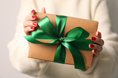 Christmas present. Woman holding gift box, closeup