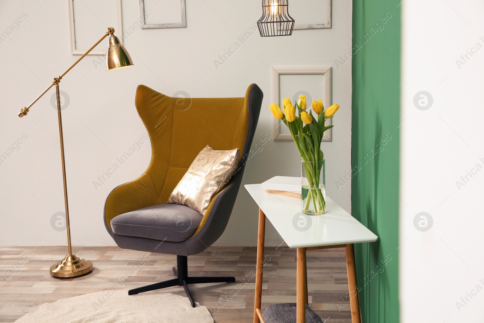 Photo of Modern interior with comfortable armchair and table near color wall