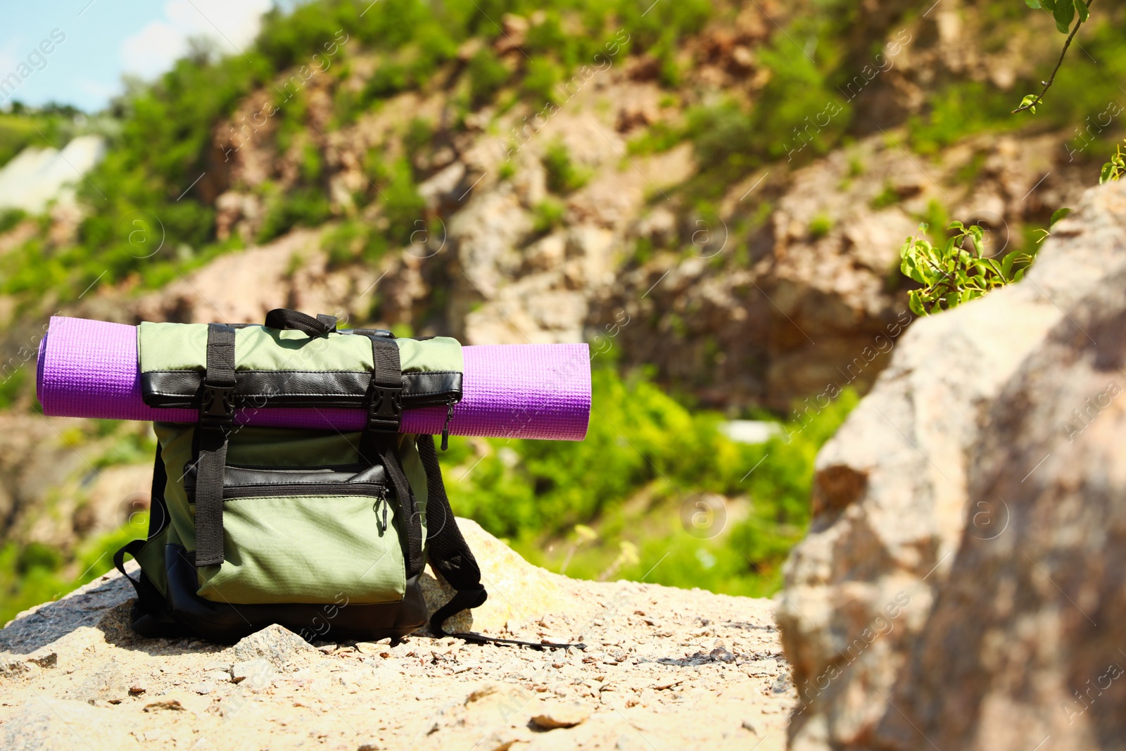 Photo of Backpack with sleeping mat outdoors on sunny day