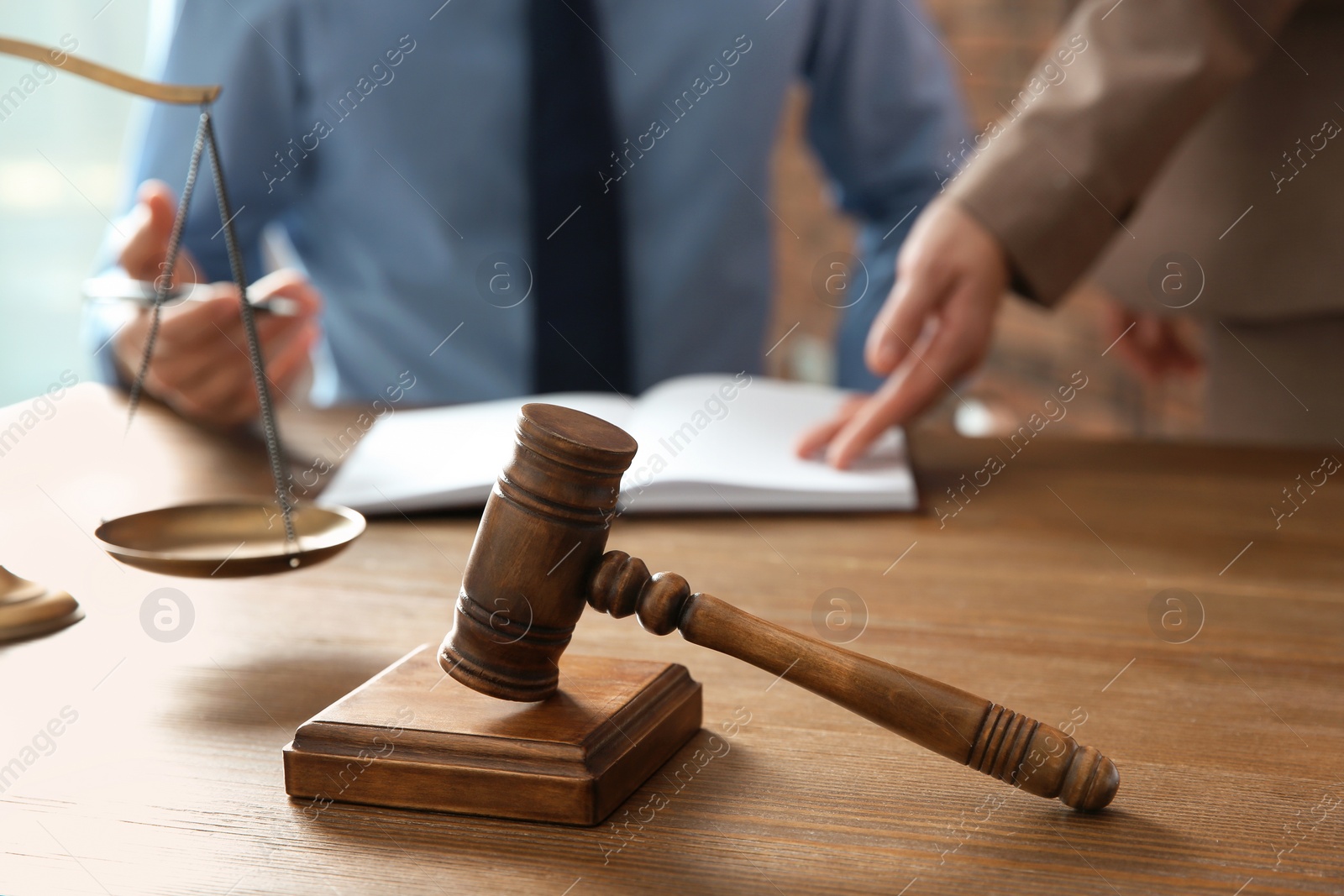 Photo of Notaries working at table in office, focus on judge gavel. Law and justice concept