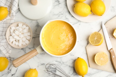 Photo of Delicious lemon curd and fresh fruits on white marble table, flat lay