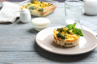 Photo of Tasty broccoli casserole served on wooden table