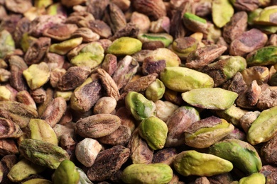 Shelled organic pistachio nuts as background, closeup