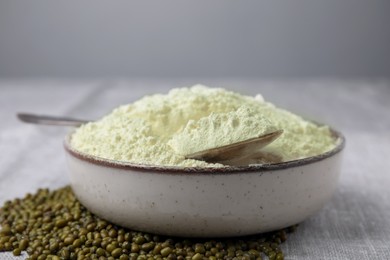 Photo of Bowl of flour and mung beans on light grey table