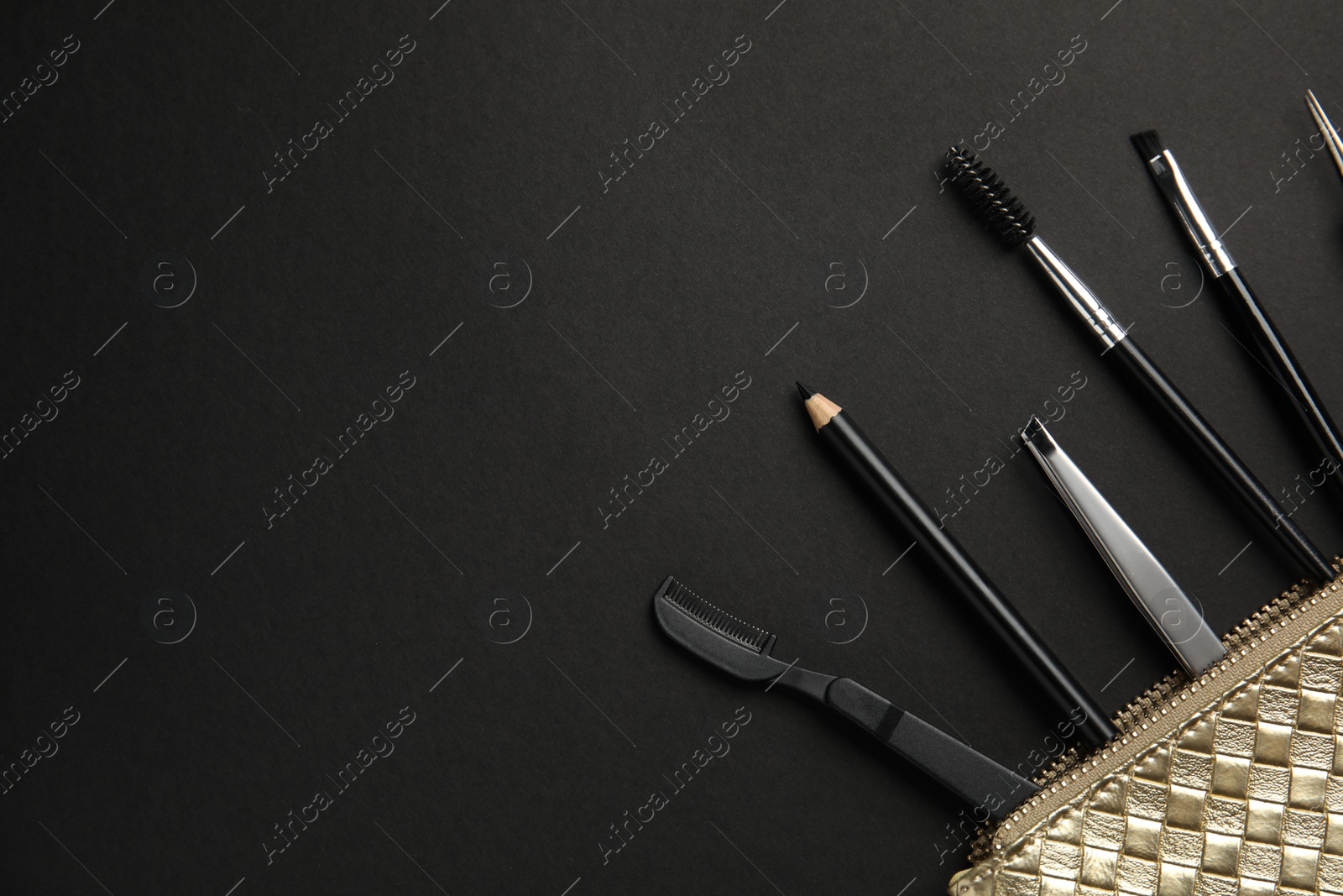 Photo of Set of professional eyebrow tools on black background, flat lay. Space for text