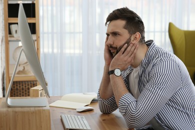 Online test. Man studying with computer at home