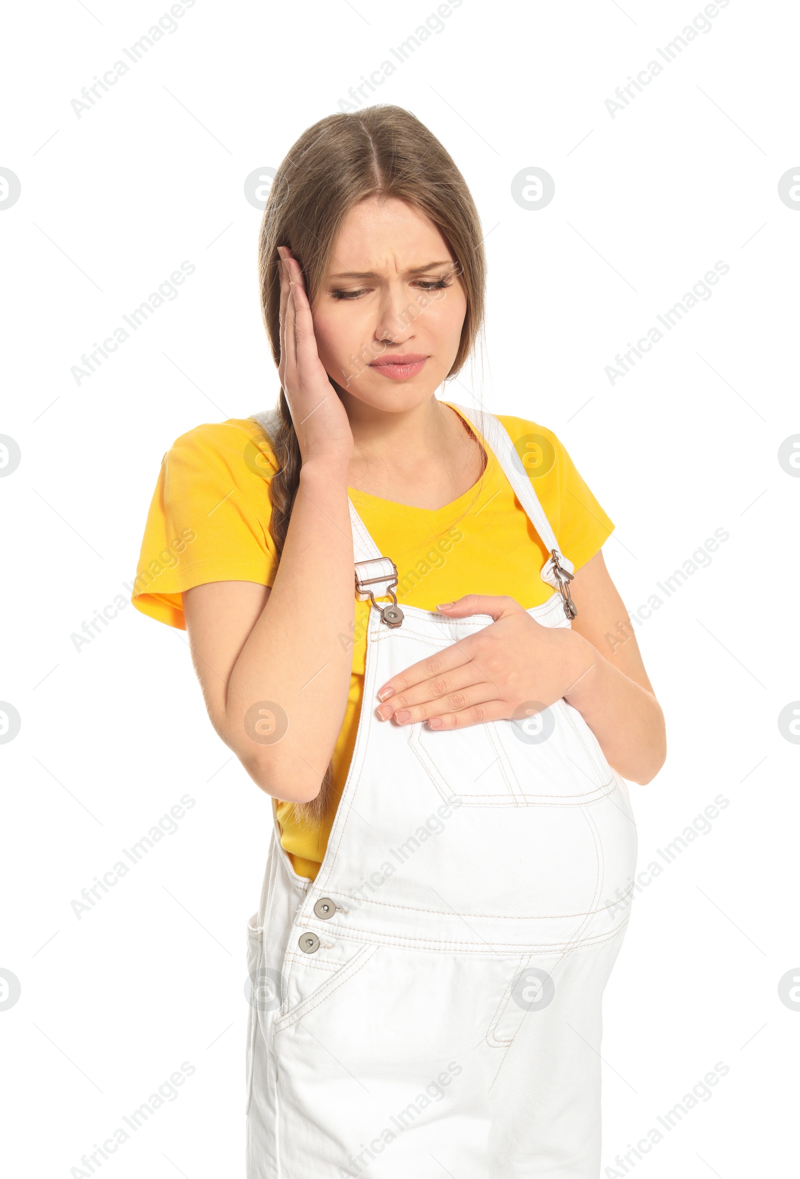 Photo of Young pregnant woman suffering from headache on white background