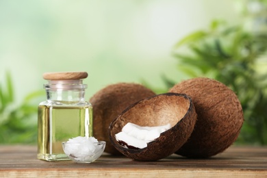 Photo of Composition with natural organic coconut oil on wooden table