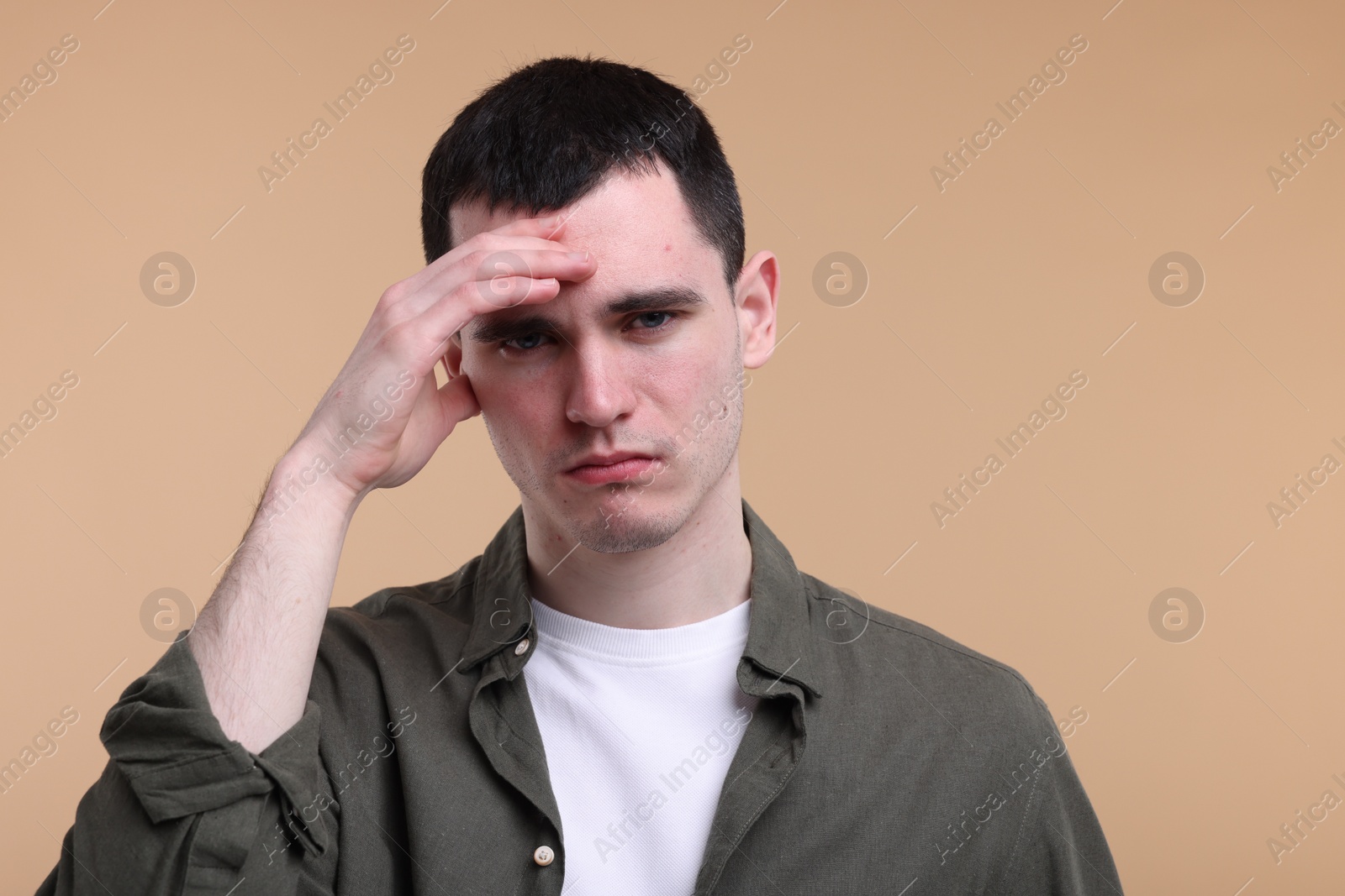 Photo of Portrait of sad man on beige background