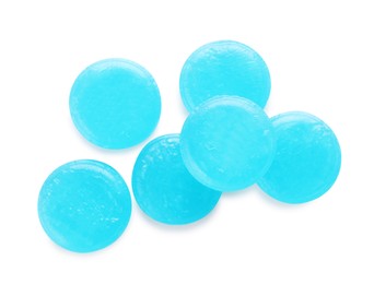 Photo of Many light blue cough drops on white background, top view