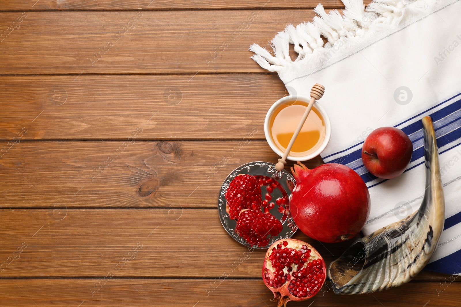 Photo of Flat lay composition with Rosh Hashanah holiday attributes on wooden table. Space for text