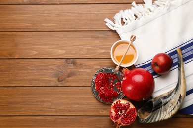 Photo of Flat lay composition with Rosh Hashanah holiday attributes on wooden table. Space for text