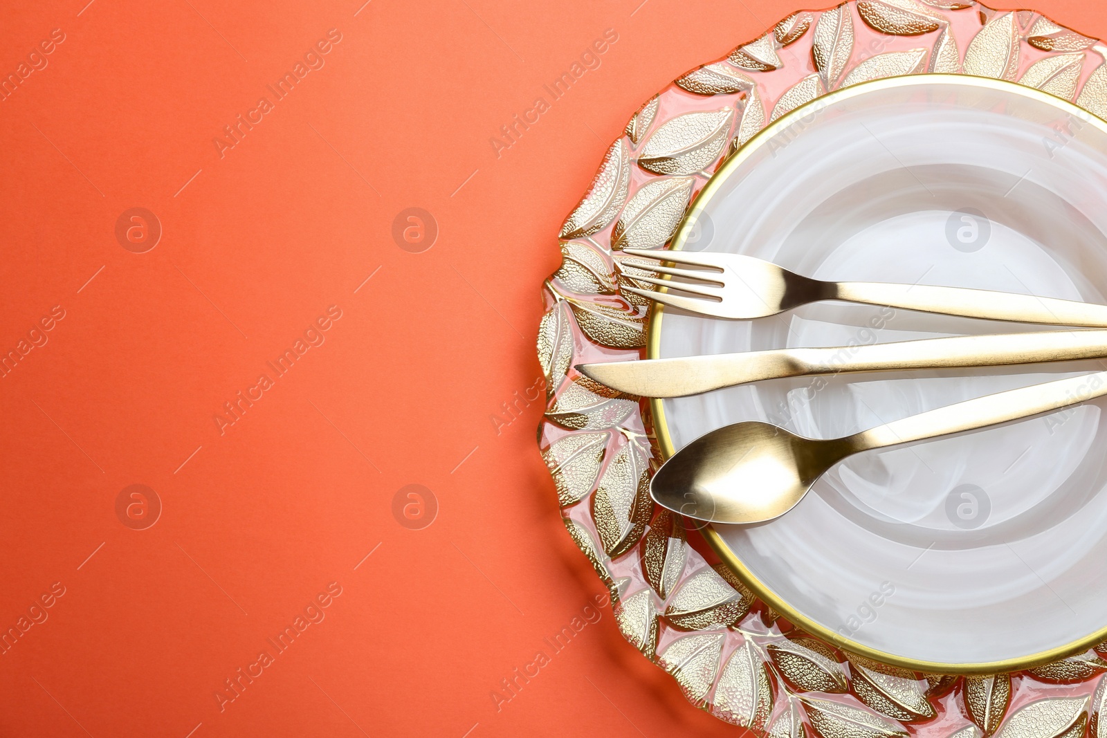 Photo of Elegant table setting on orange background, flat lay. Space for text