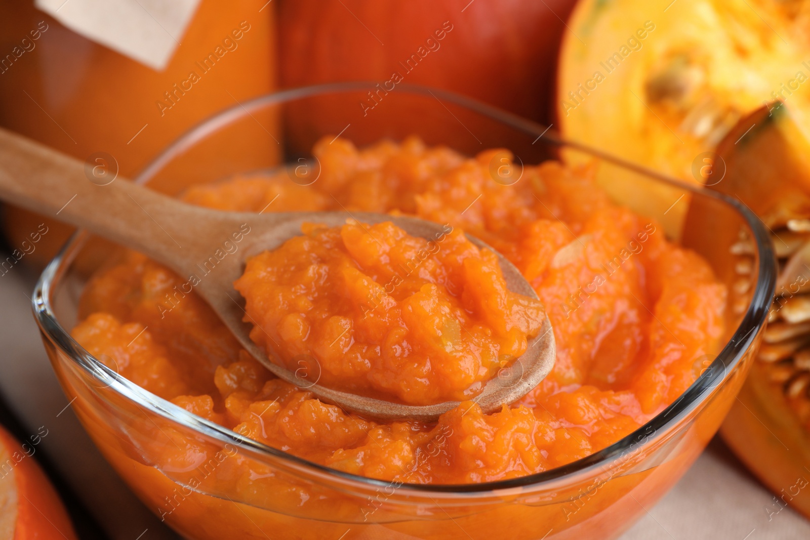 Photo of Bowl of tasty pumpkin jam on table, closeup