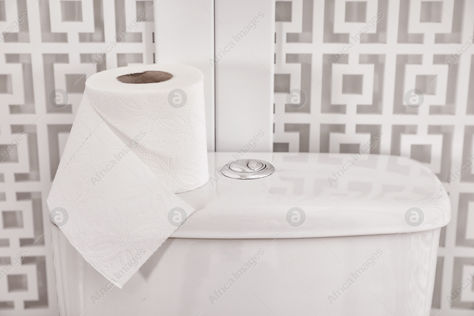 Photo of Roll of paper on toilet tank in bathroom, closeup