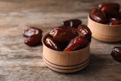 Bowl with sweet dates on table. Dried fruit as healthy snack
