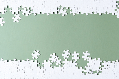 Photo of Blank white puzzle pieces on grey background, flat lay. Space for text