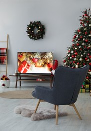 Stylish living room interior with modern TV and Christmas tree