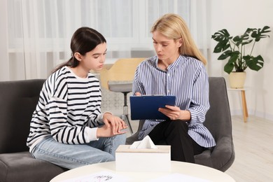 Photo of Psychologist working with teenage girl in office. Teenager problems