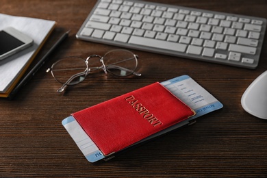 Composition with passport on wooden table. Travel agency concept