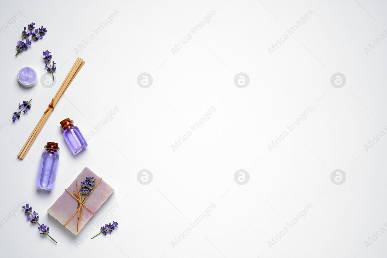 Photo of Cosmetic products and lavender flowers on white background, flat lay