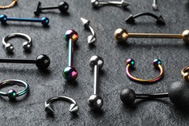 Photo of Stylish jewelry for piercing on grey table, closeup