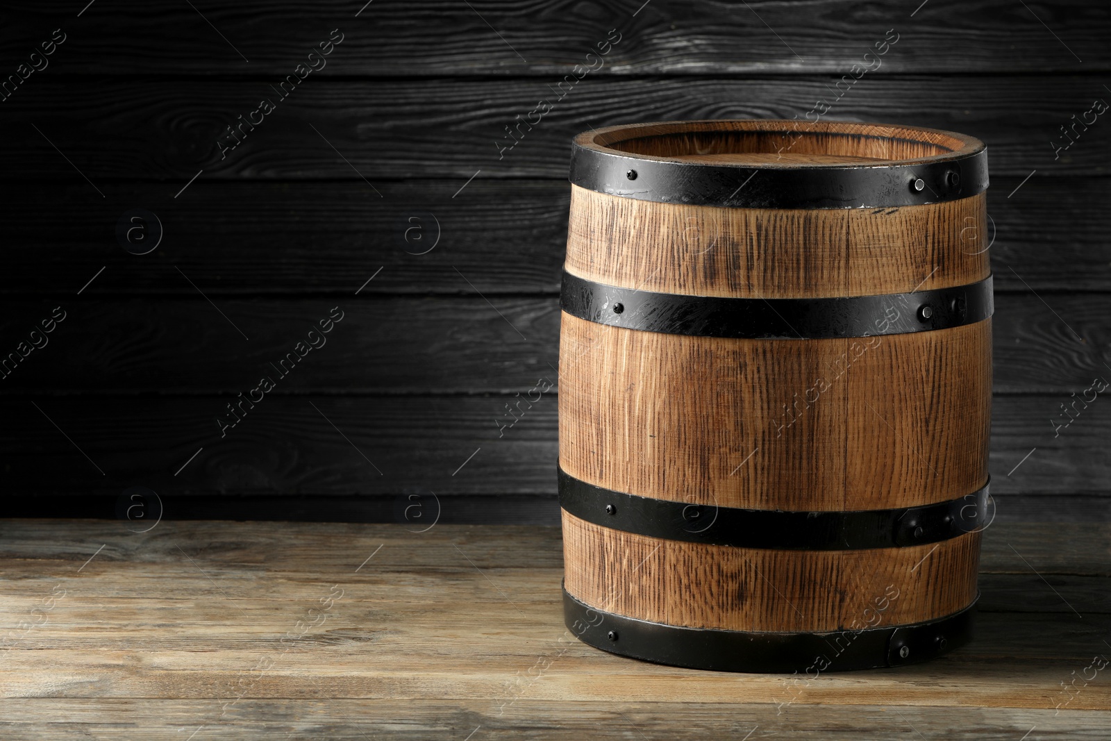 Photo of Wooden barrel on table, space for text