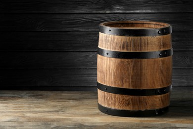 Wooden barrel on table, space for text