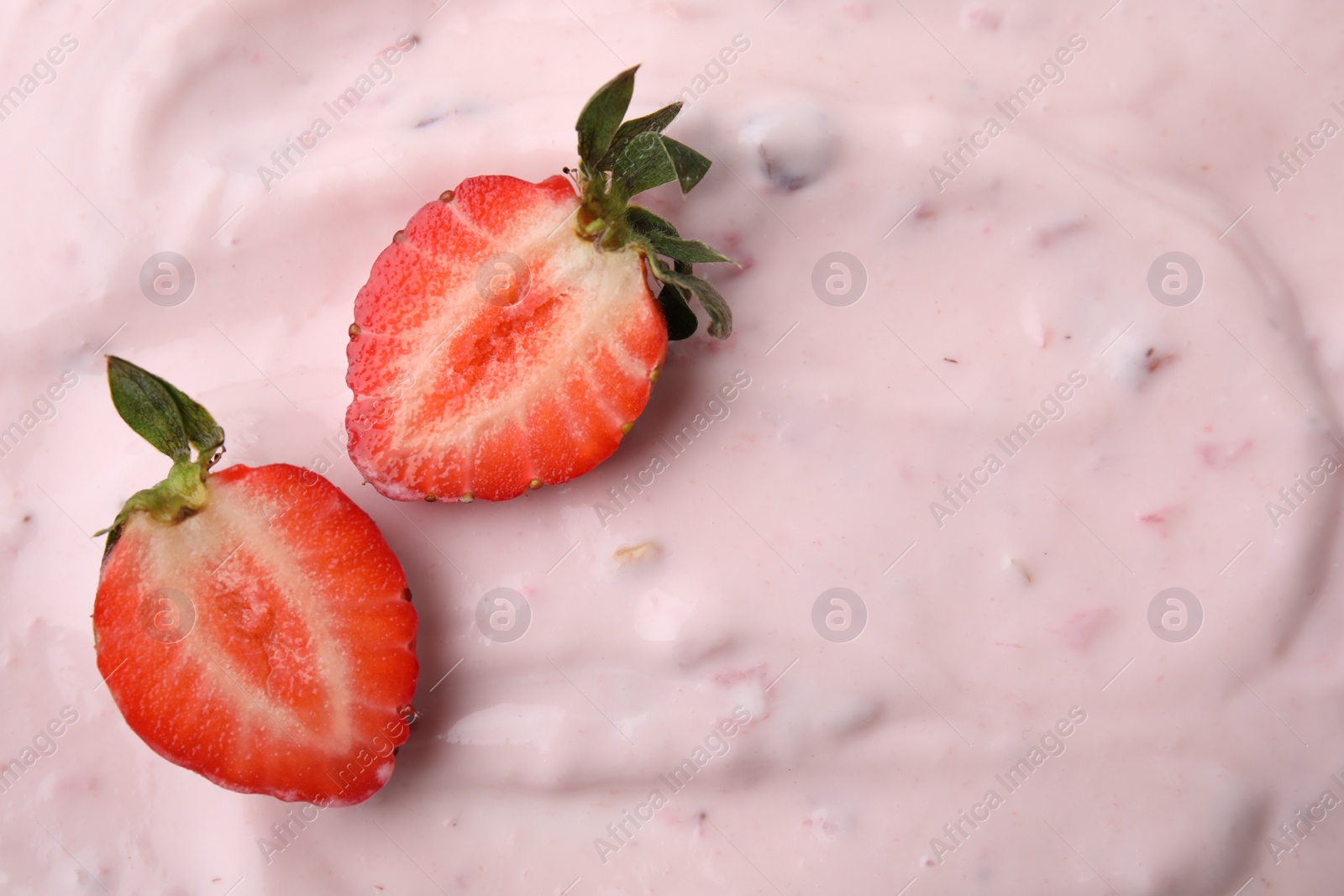 Photo of Tasty yogurt and strawberries as background, top view. Space for text