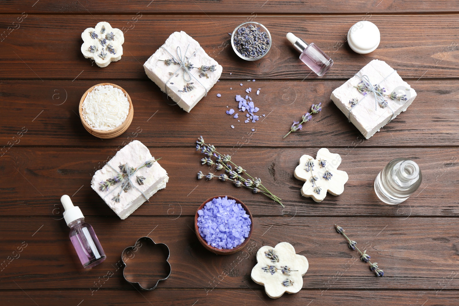 Photo of Flat lay composition with hand made soap bars and lavender flowers on wooden table