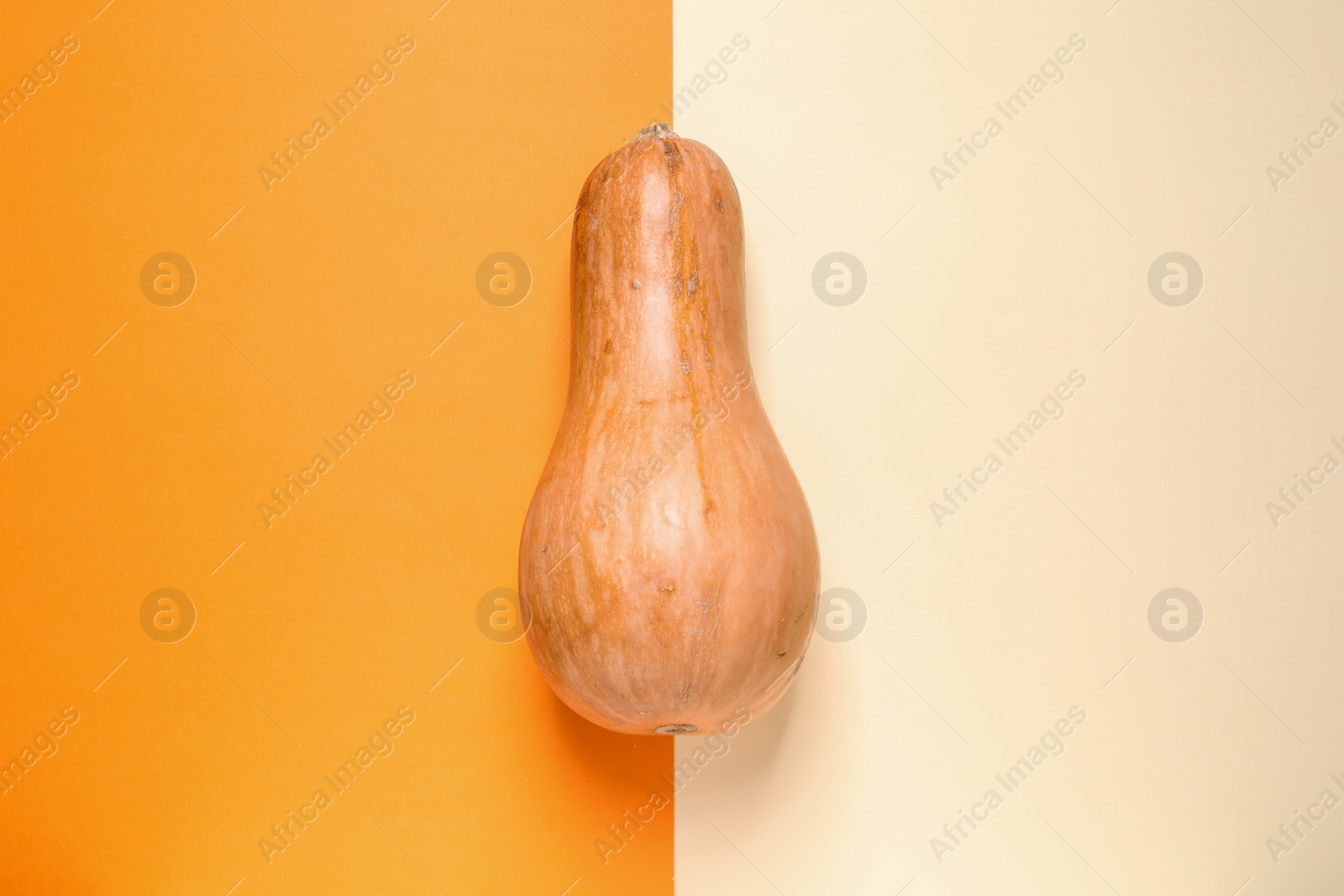 Photo of Orange pumpkin on color background, top view. Autumn holidays