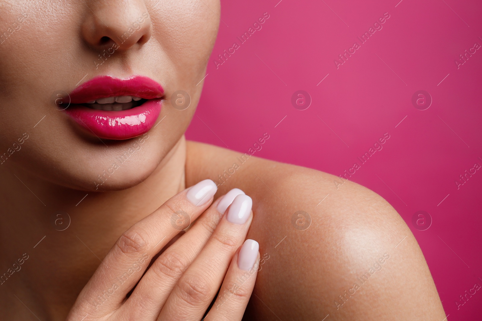 Photo of Closeup view of woman with beautiful lips on pink background. Space for text