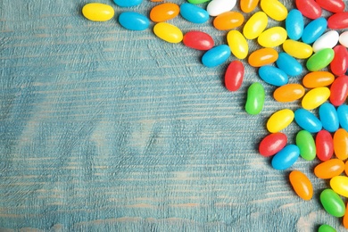 Flat lay composition with jelly beans on color background. Space for text