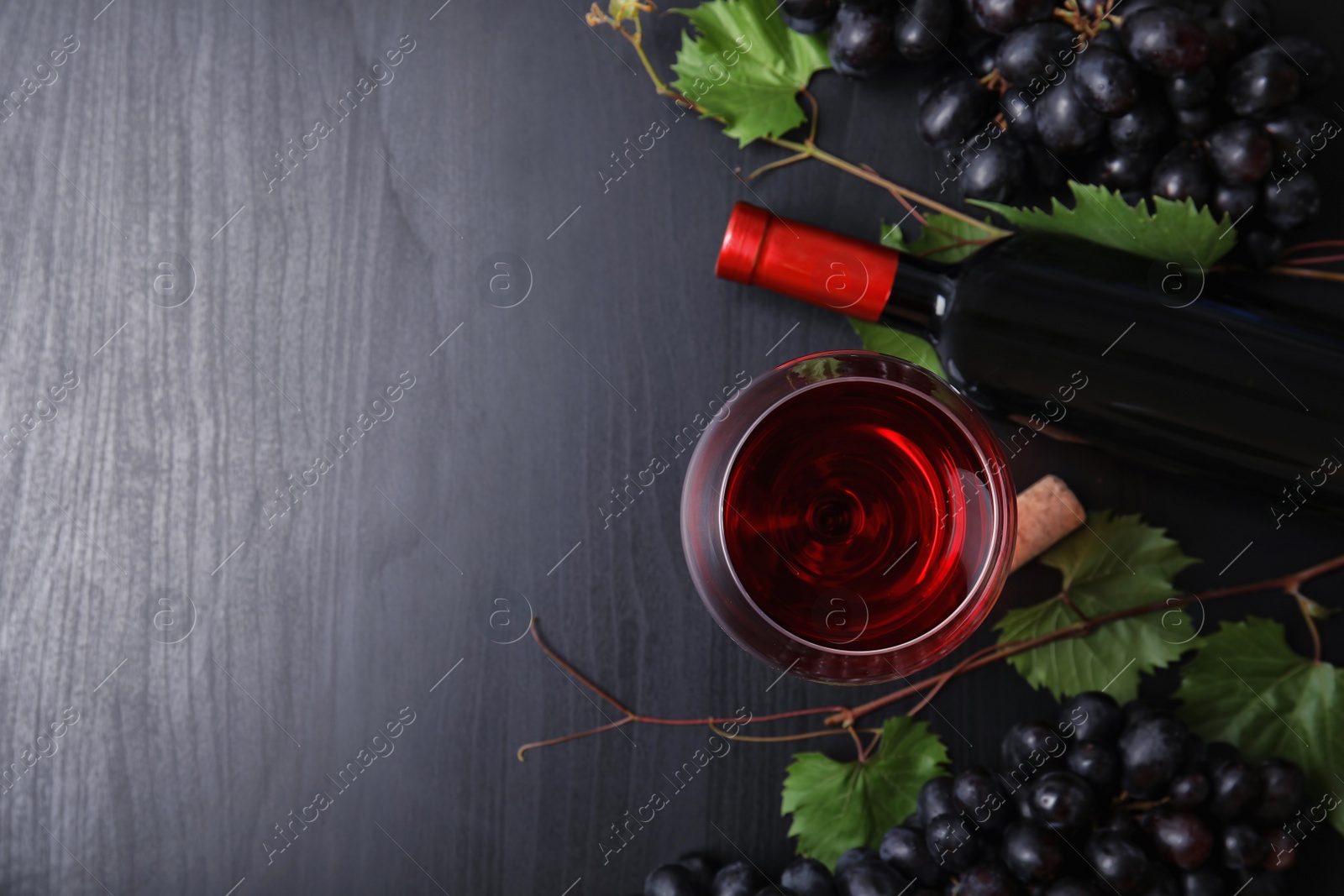 Photo of Flat lay composition with fresh ripe juicy grapes and space for text on wooden background