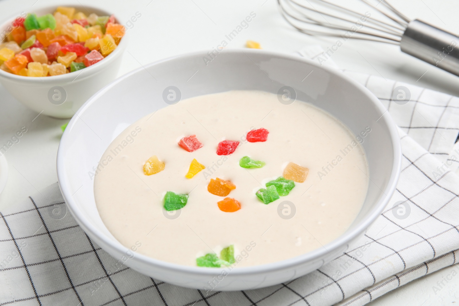 Photo of Raw dough with candied fruits for cookies on white table, closeup