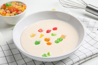 Raw dough with candied fruits for cookies on white table, closeup