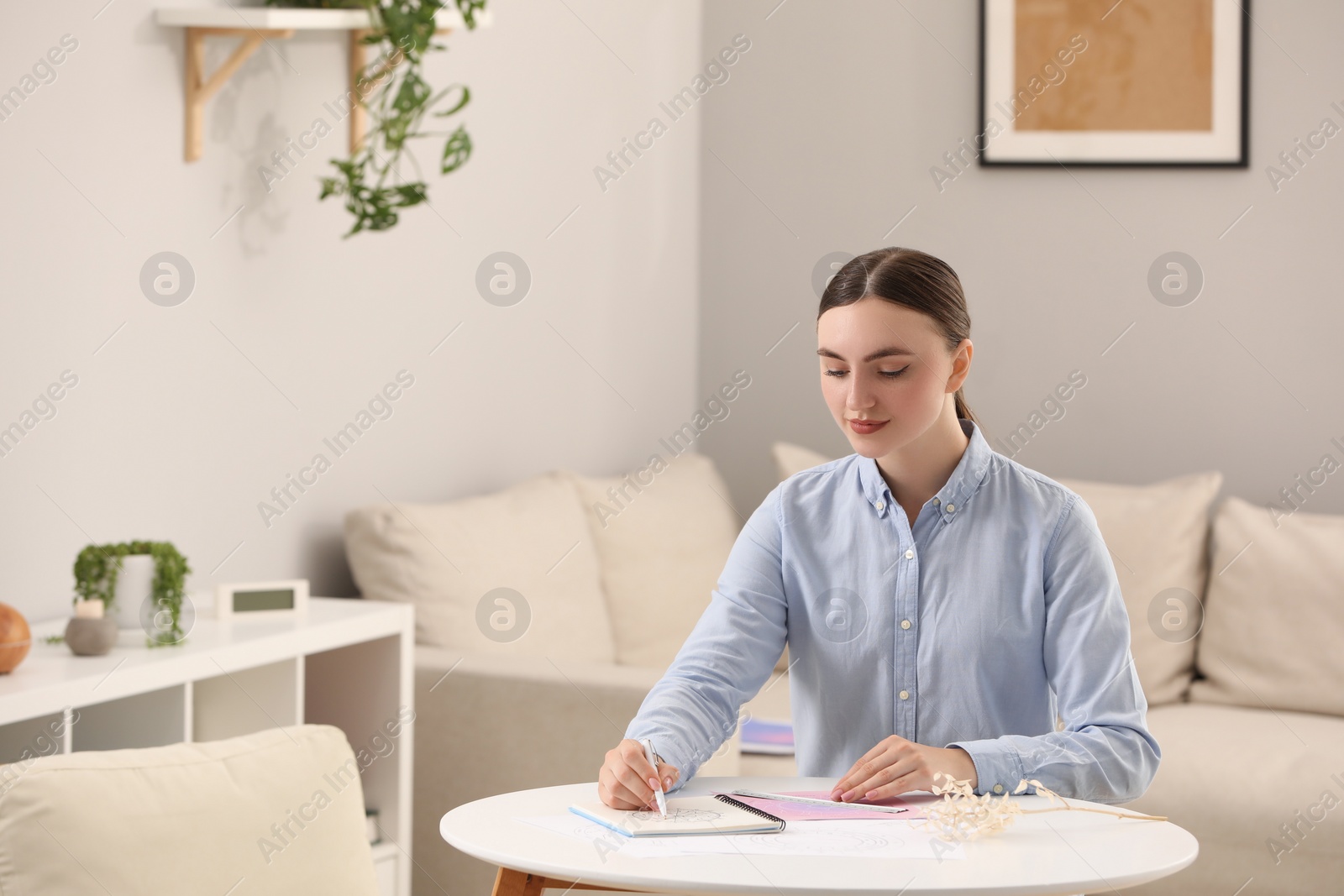 Photo of Astrologer making fate forecast at table indoors, space for text. Fortune telling
