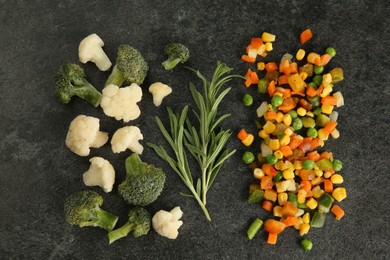Photo of Mix of different frozen vegetables and rosemary on gray table, flat lay