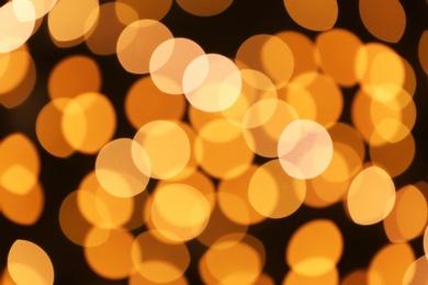 Beautiful golden lights on dark background. Bokeh effect