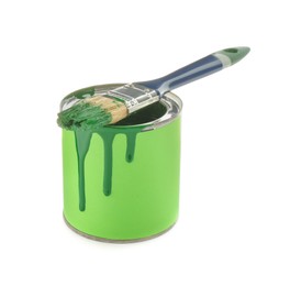 Photo of Can of green paint with brush on white background