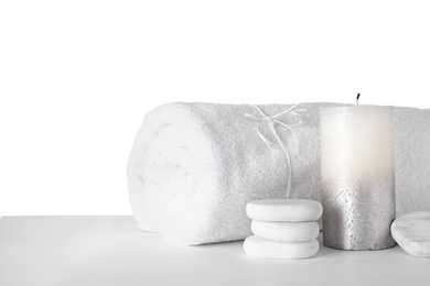 Photo of Towel, spa stones and candle isolated on white