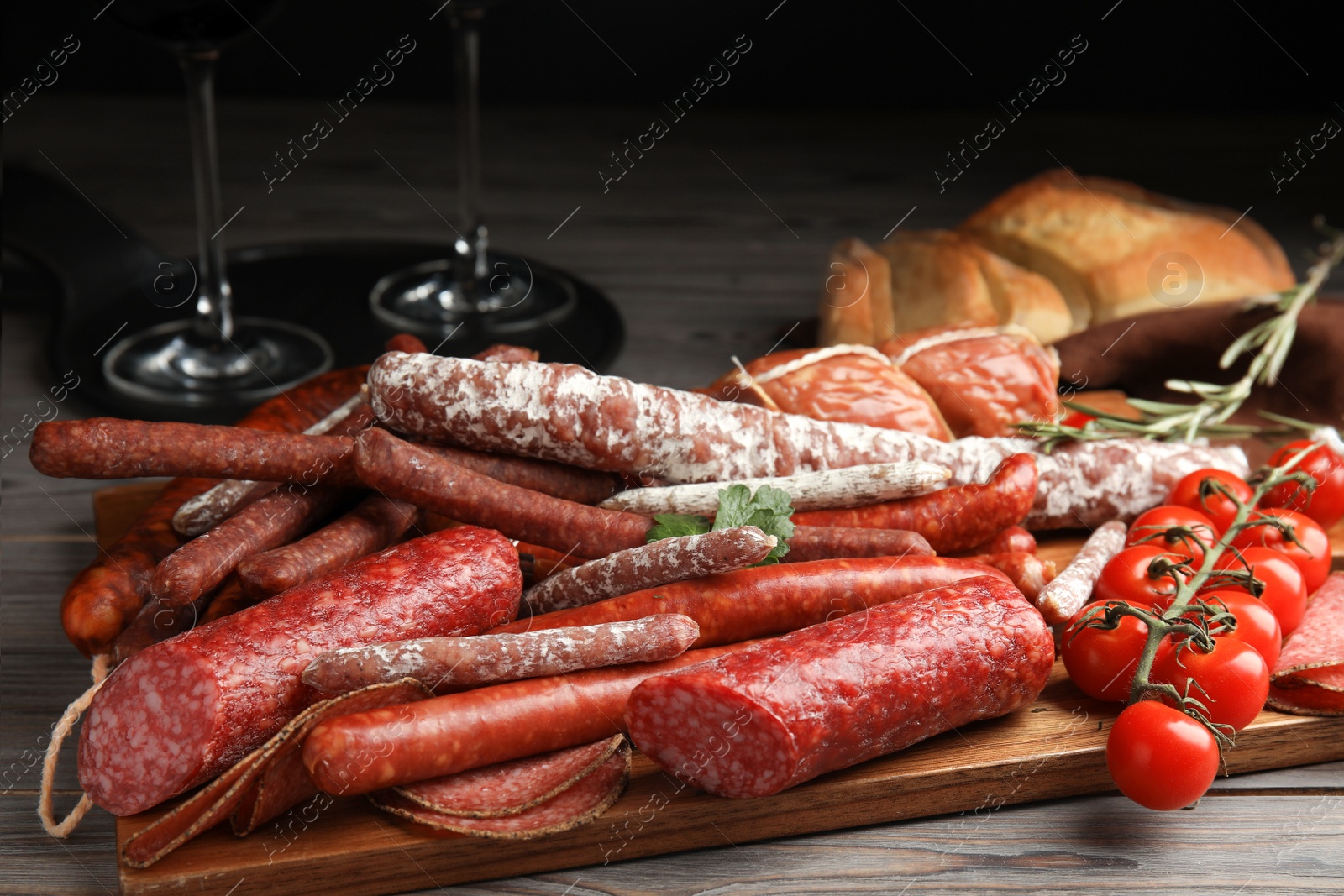 Photo of Different tasty sausages on wooden table, closeup