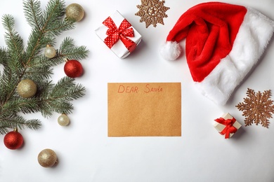 Photo of Flat lay composition with childish letter to Santa Claus and Christmas decoration on white background