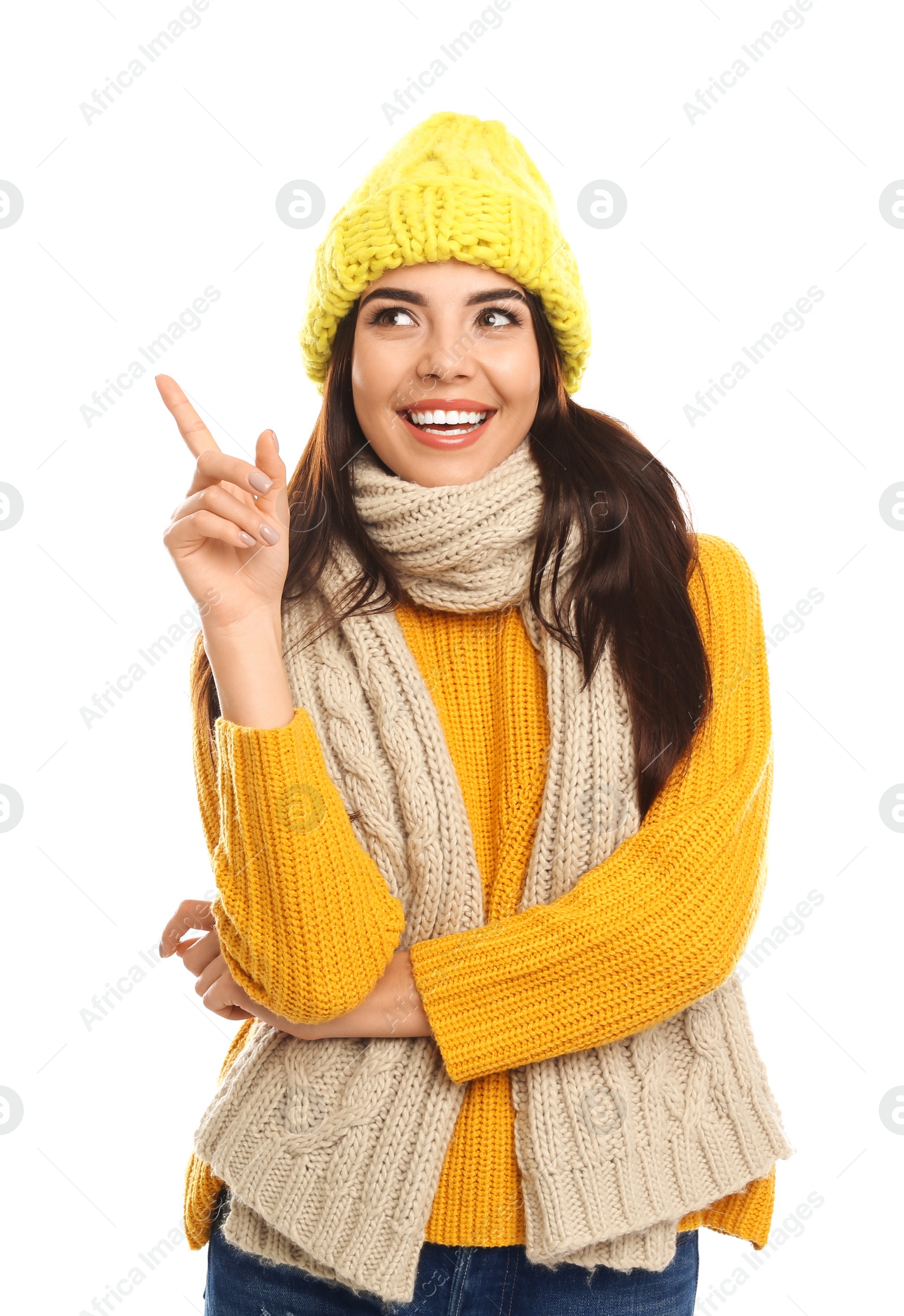 Photo of Happy young woman in warm clothes on white background. Winter vacation