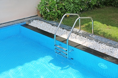 Modern swimming pool with stairs, outdoors