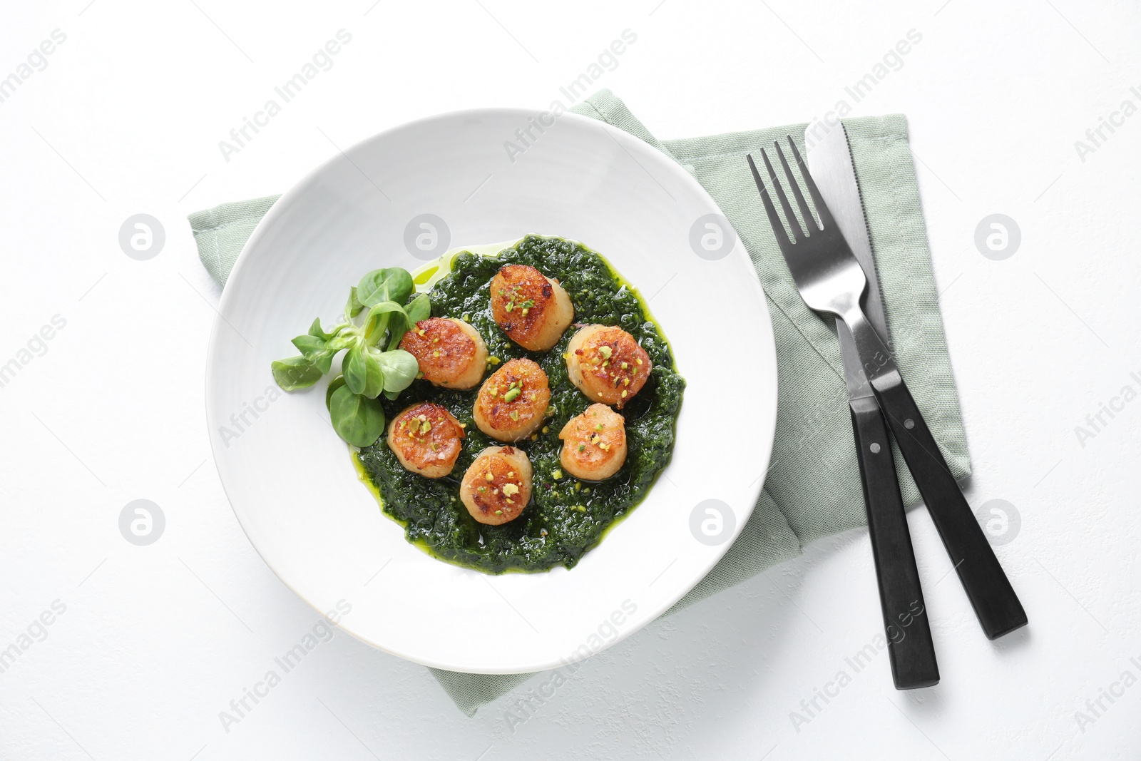 Photo of Delicious fried scallops in bowl served on white table, flat lay