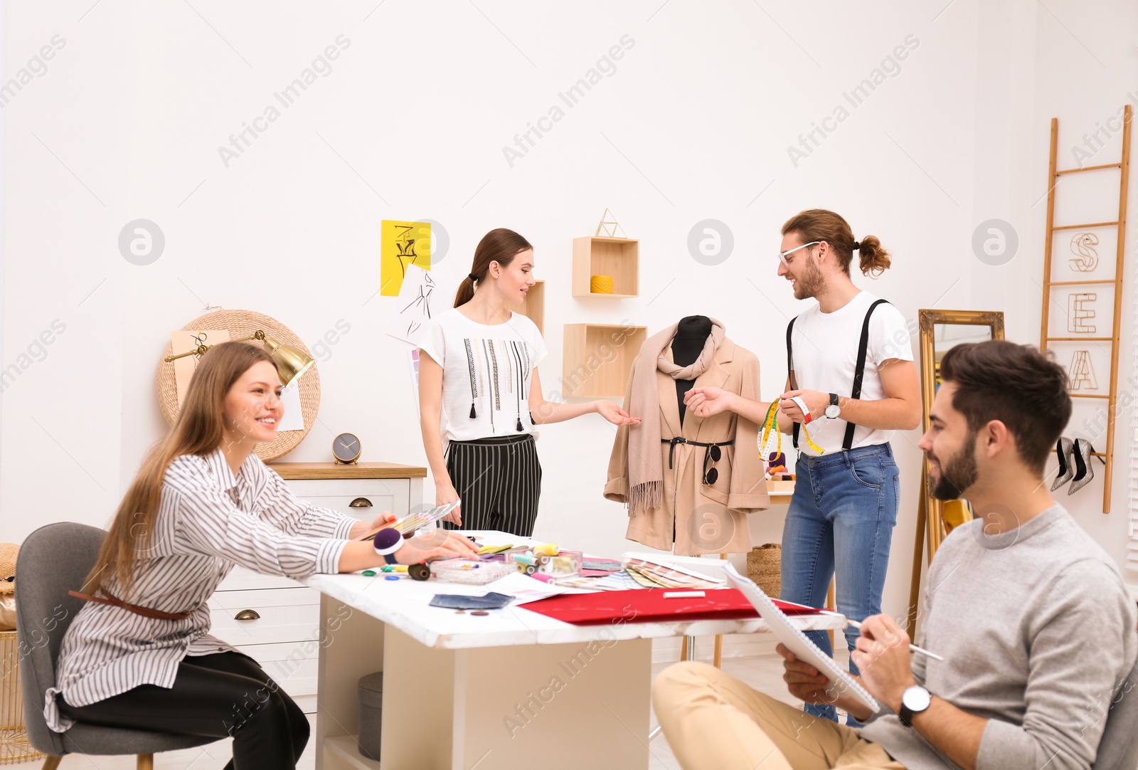 Photo of Fashion designers creating new clothes in studio