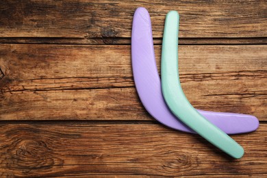 Photo of Boomerangs on wooden background, flat lay. Space for text